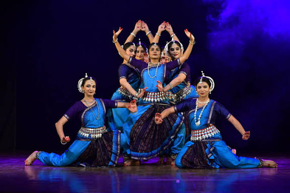 Indian classical dancer executing Kathak mudras with ghungroo bells